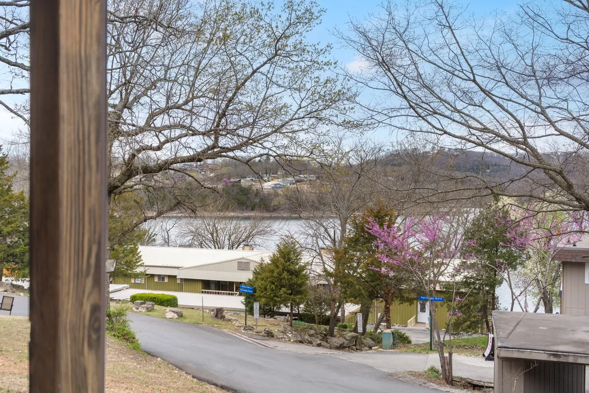 A tranquil riverside scene featuring water with reflections, surrounding trees, and distant hills. The peaceful setting invites exploration, relaxation, and moments of quiet connection with nature, capturing the essence of outdoor activities like strolling along the lakeshore or exploring nature trails.